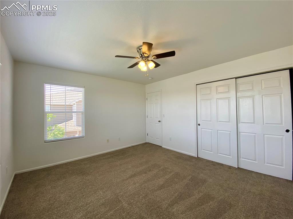 7513 Sandy Springs Point Fountain, CO 80817 - Photo 22 of 38 a view of a room with a ceiling fan and a window