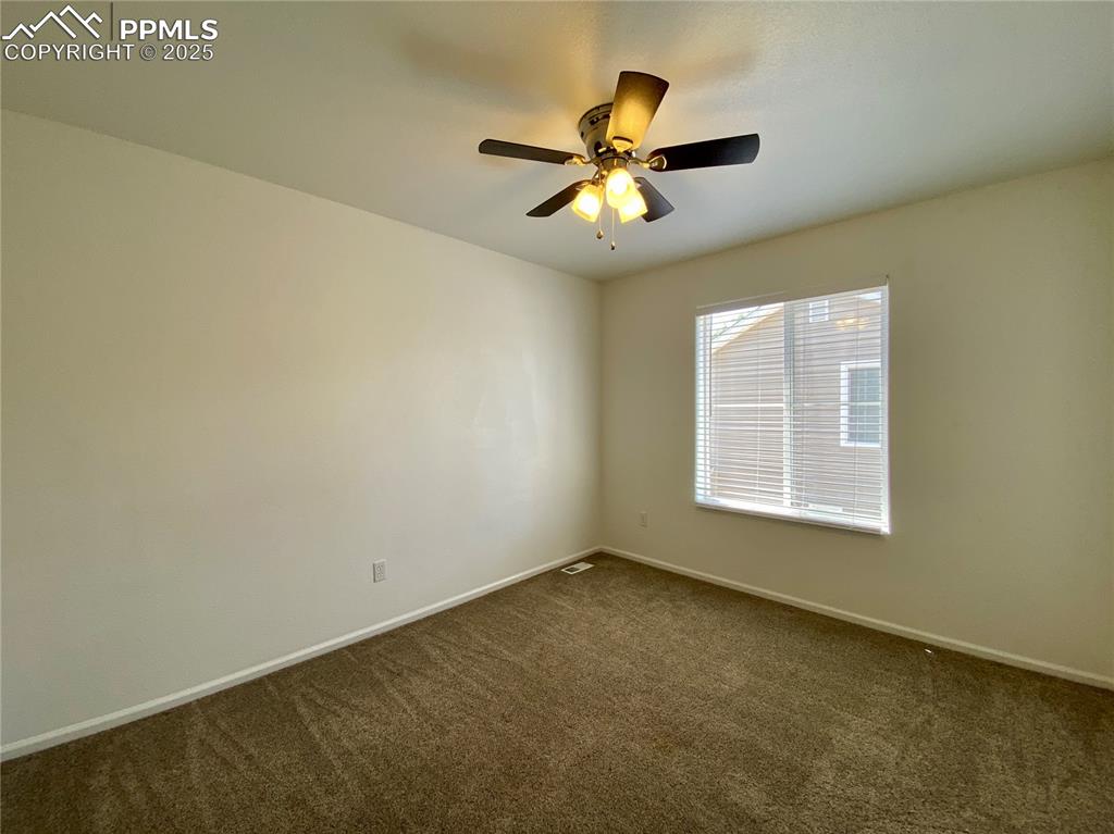 7513 Sandy Springs Point Fountain, CO 80817 - Photo 26 of 38 an empty room with windows and fan