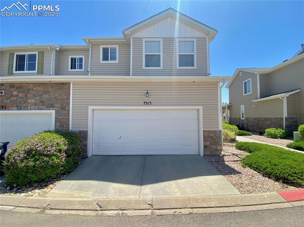7513 Sandy Springs Point Fountain, CO 80817 - Photo 33 of 38 a front view of a house with a yard and garage