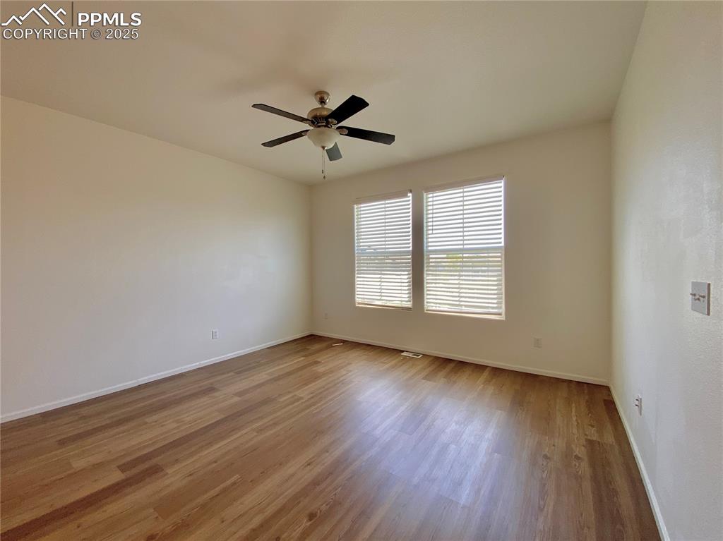 7513 Sandy Springs Point Fountain, CO 80817 - Photo 4 of 38 a view of empty room with wooden floor and fan