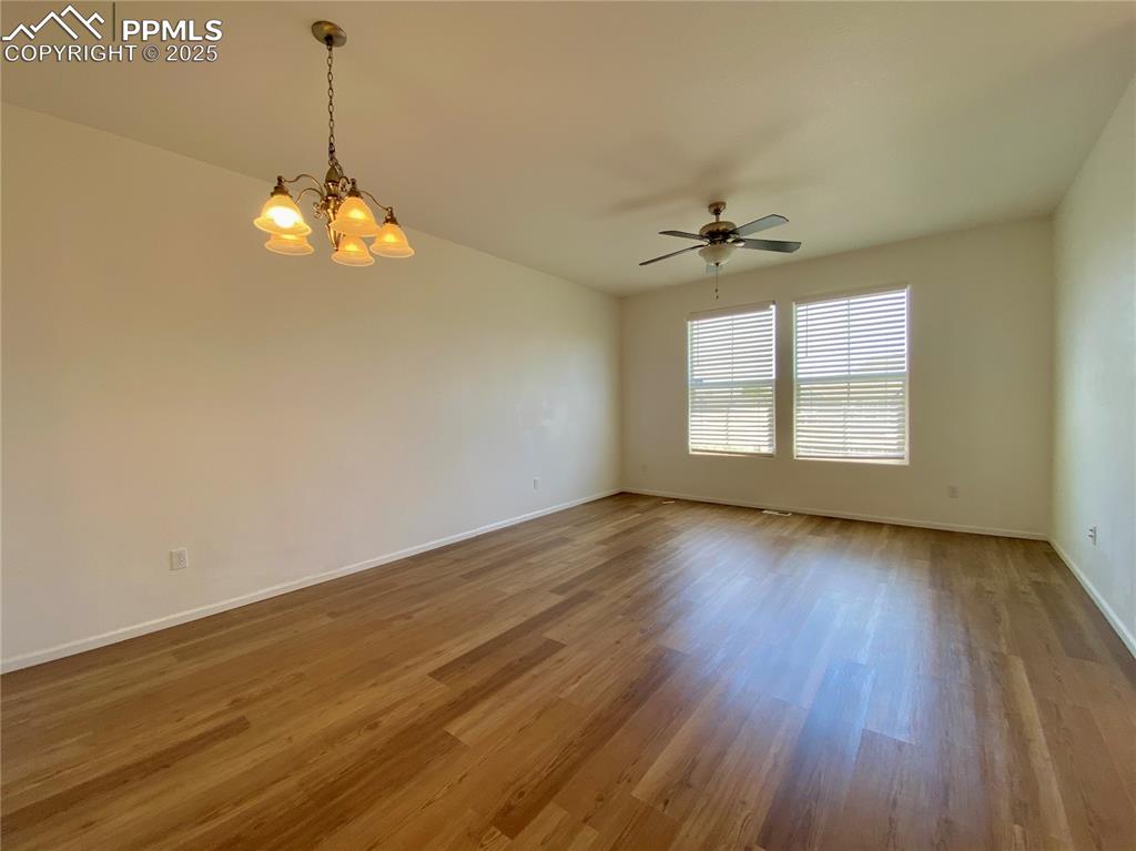 7513 Sandy Springs Point Fountain, CO 80817 - Photo 5 of 38 a view of a room with wooden floor and chandelier