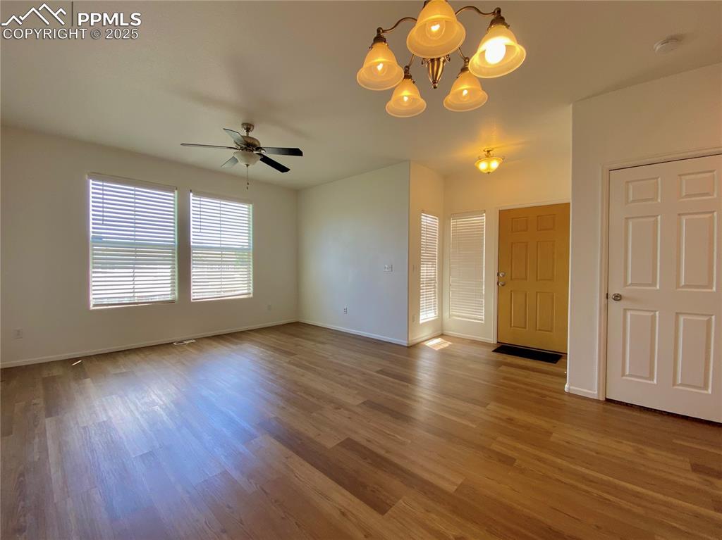 7513 Sandy Springs Point Fountain, CO 80817 - Photo 6 of 38 an empty room with wooden floor and windows