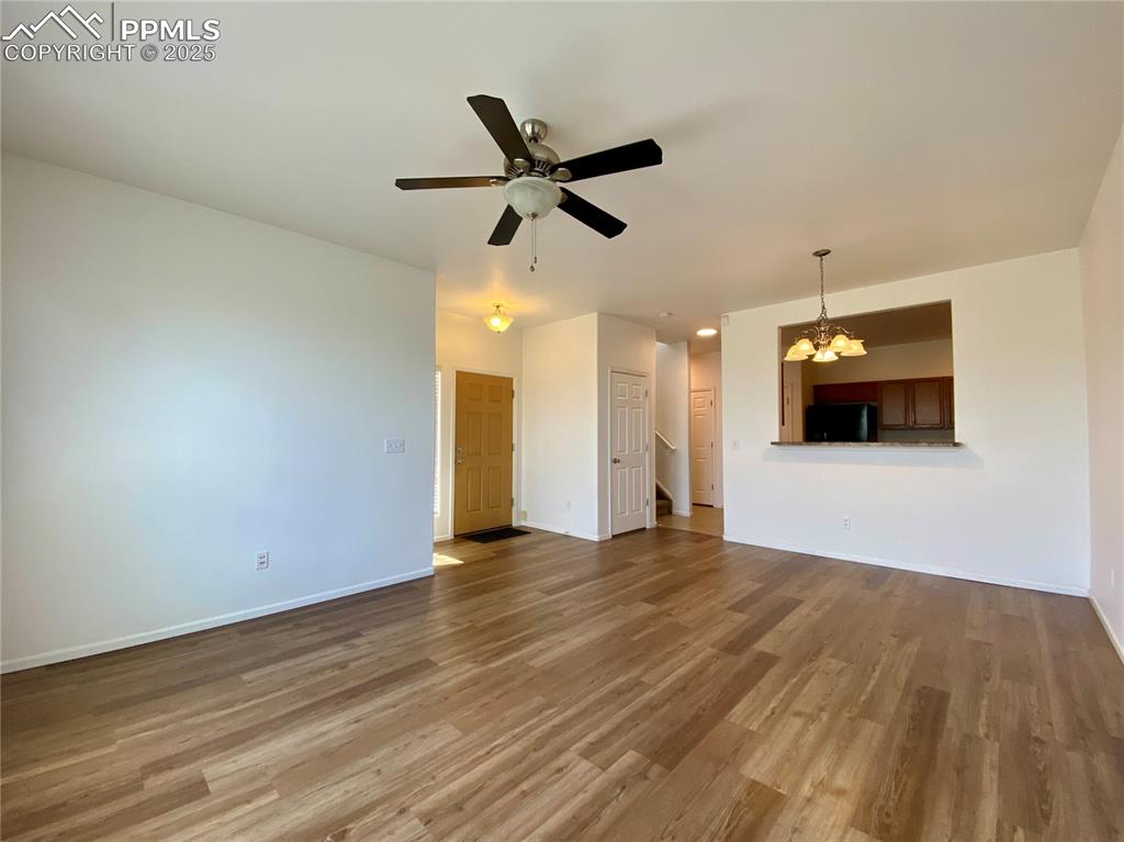 7513 Sandy Springs Point Fountain, CO 80817 - Photo 7 of 38 a view of empty room with wooden floor and ceiling fan