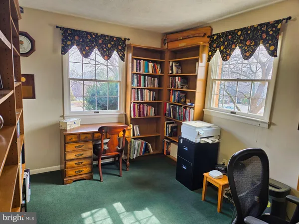 a dining room with furniture a chandelier and window