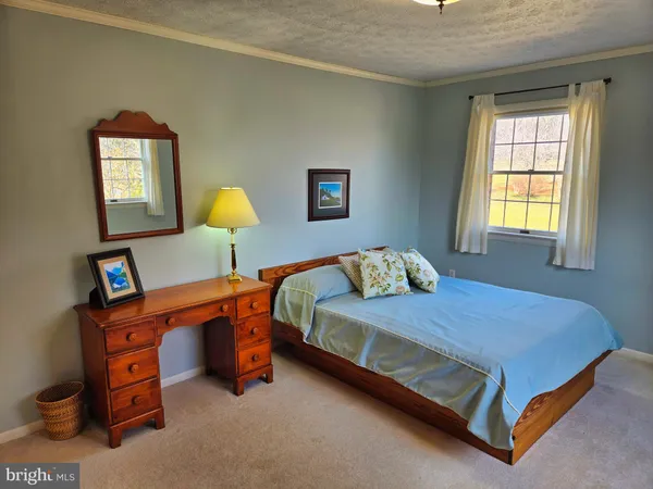 a bedroom with a bed and a lamp on table