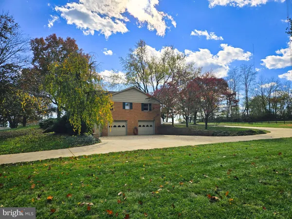a front view of house with yard and trees