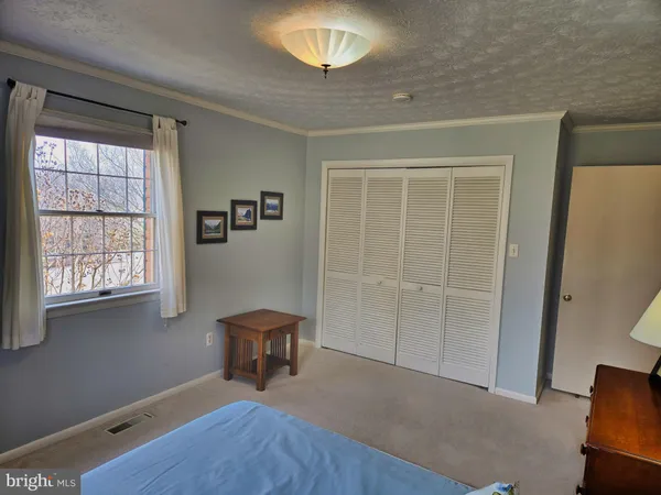 a bed sitting in a room next to a window