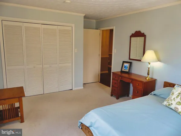 a bedroom with bed and a window