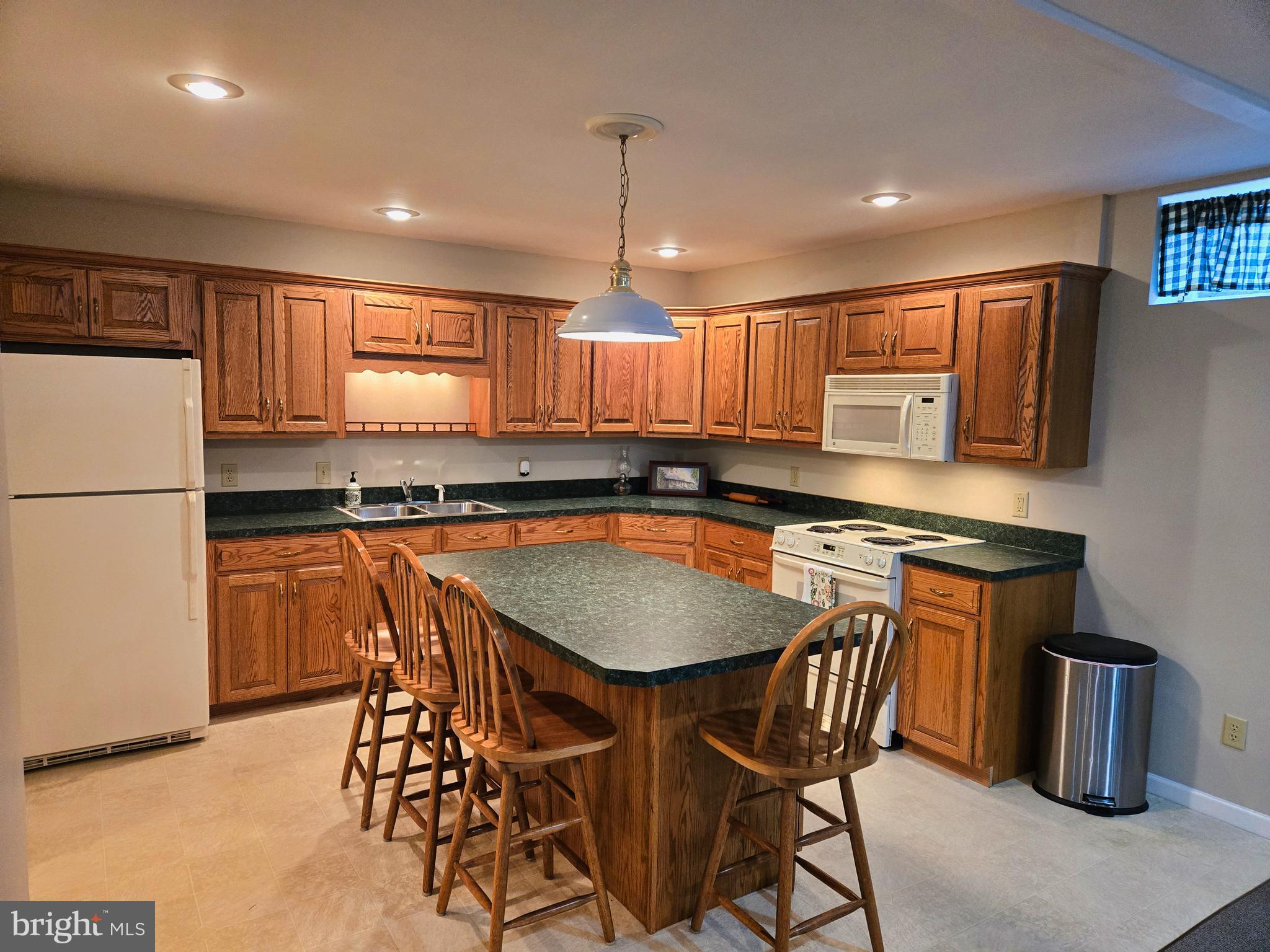 174 Rorrer Circle Harrisonburg, VA 22801 - Photo 41 of 52 a kitchen with stainless steel appliances granite countertop a stove a sink a refrigerator a microwave a dining table and chairs with wooden floor