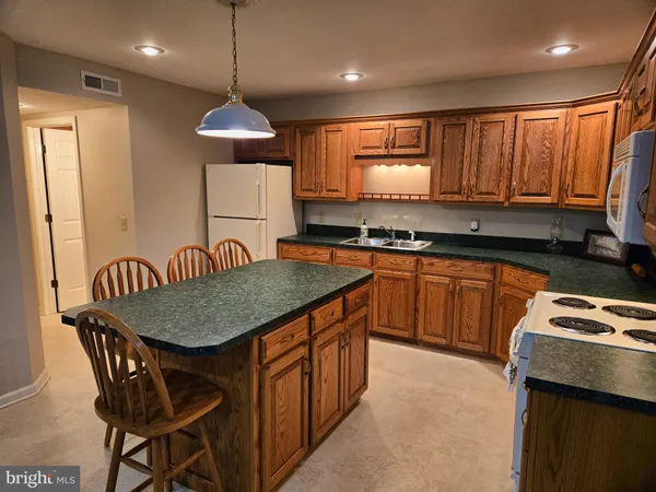 an empty room with furniture and a flat screen tv