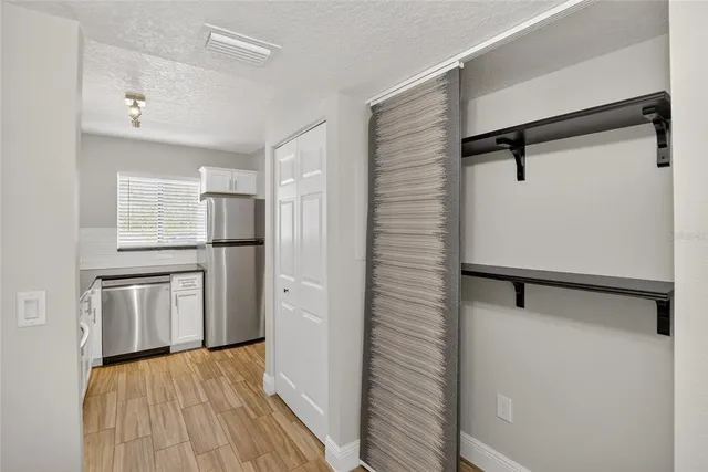 a kitchen with a refrigerator and a stove top oven