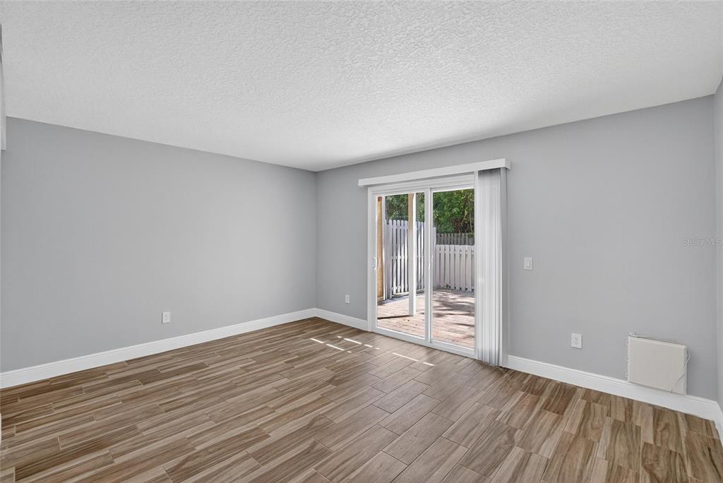 4415 Dylan Loop, Unit 179 Land O' Lakes, FL 34639 - Photo 15 of 50 a view of an empty room with wooden floor and a window