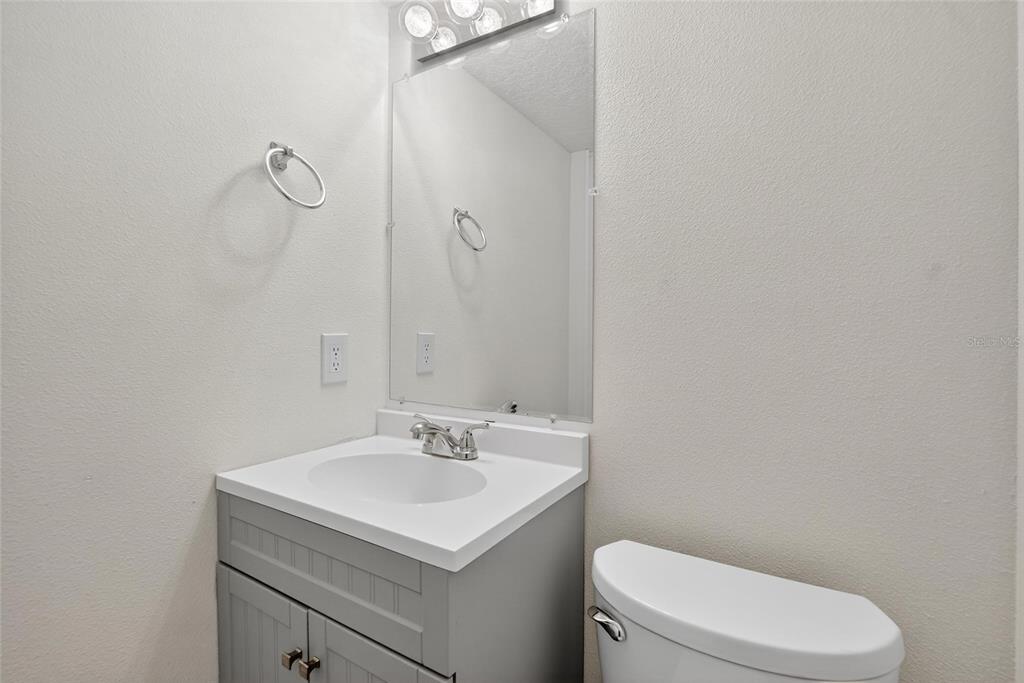 4415 Dylan Loop, Unit 179 Land O' Lakes, FL 34639 - Photo 19 of 50 a bathroom with a sink a toilet and vanity