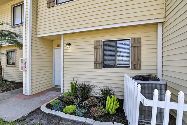 a front view of a house with plants