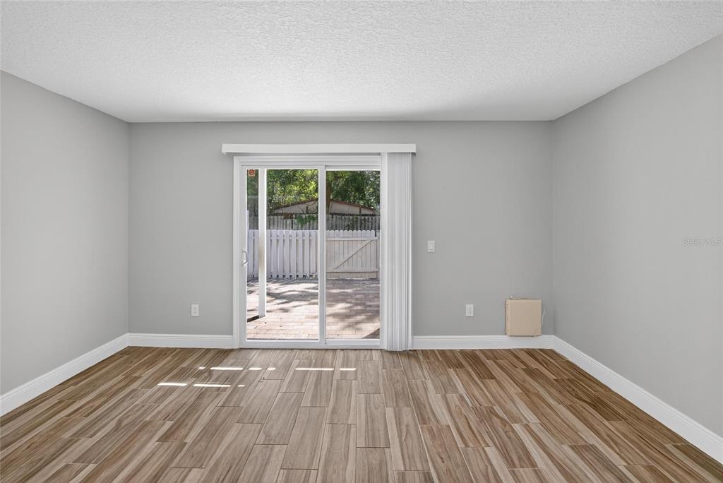 4415 Dylan Loop, Unit 179 Land O' Lakes, FL 34639 - Photo 21 of 50 a view of an empty room with wooden floor and a window