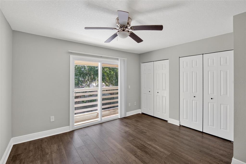 4415 Dylan Loop, Unit 179 Land O' Lakes, FL 34639 - Photo 27 of 50 an empty room with wooden floor ceiling fan and windows
