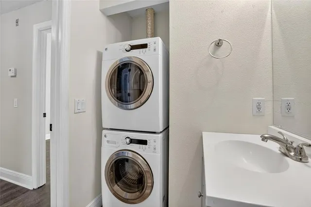 a bathroom with a sink and a washer dryer