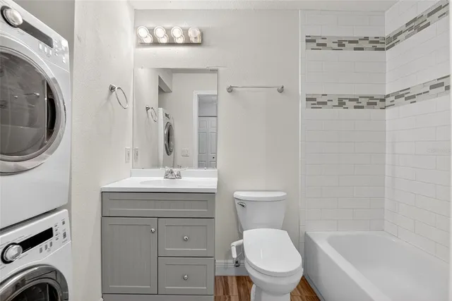 a bathroom with a granite countertop toilet sink and mirror