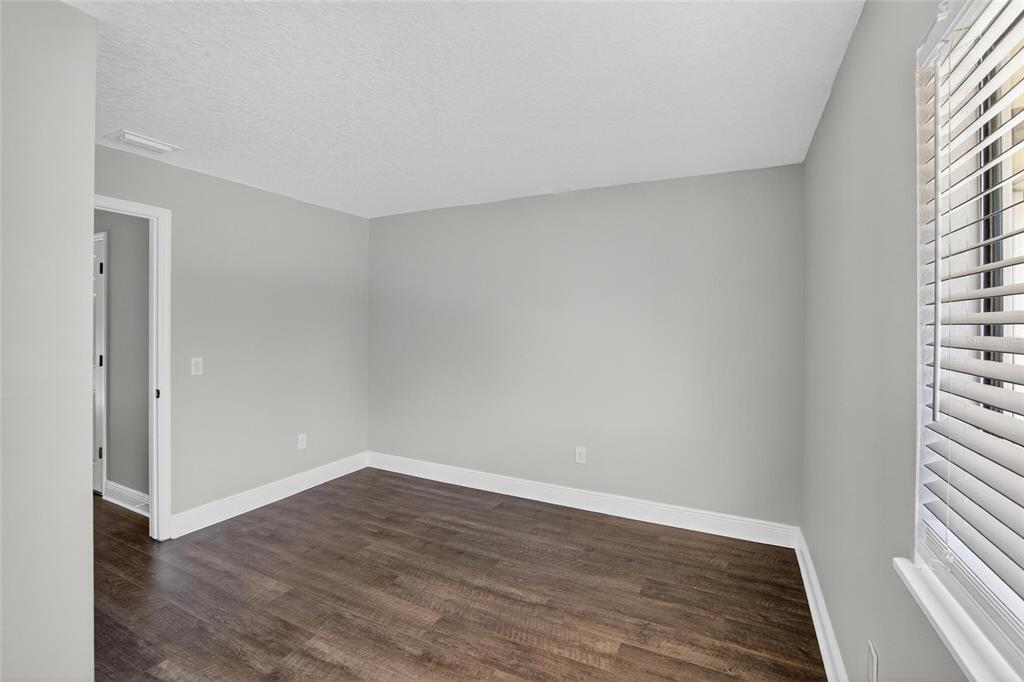 4415 Dylan Loop, Unit 179 Land O' Lakes, FL 34639 - Photo 33 of 50 a view of an empty room with wooden floor and a window