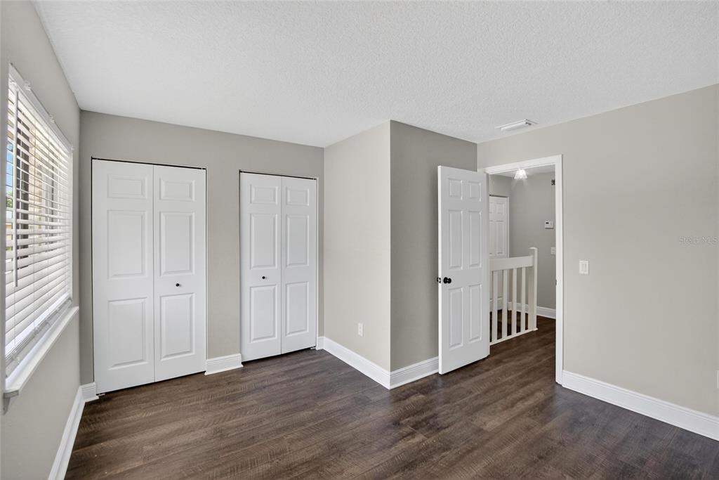 4415 Dylan Loop, Unit 179 Land O' Lakes, FL 34639 - Photo 34 of 50 an empty room with wooden floor and windows