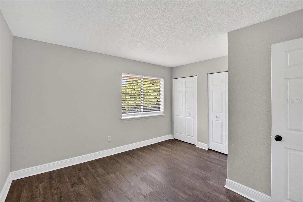 4415 Dylan Loop, Unit 179 Land O' Lakes, FL 34639 - Photo 35 of 50 an empty room with wooden floor and windows