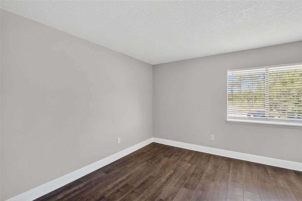4415 Dylan Loop, Unit 179 Land O' Lakes, FL 34639 - Photo 36 of 50 wooden floor in an empty room with a window