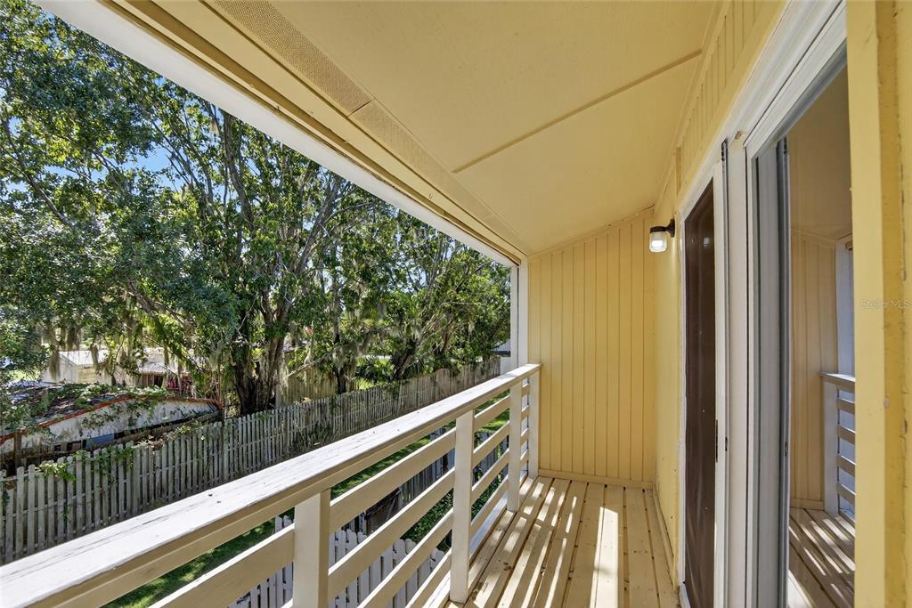 4415 Dylan Loop, Unit 179 Land O' Lakes, FL 34639 - Photo 38 of 50 a view of balcony with wooden floor and fence