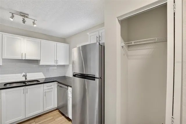 a kitchen with a refrigerator and cabinets