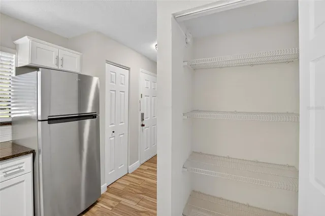 a view of walk in closet with empty racks