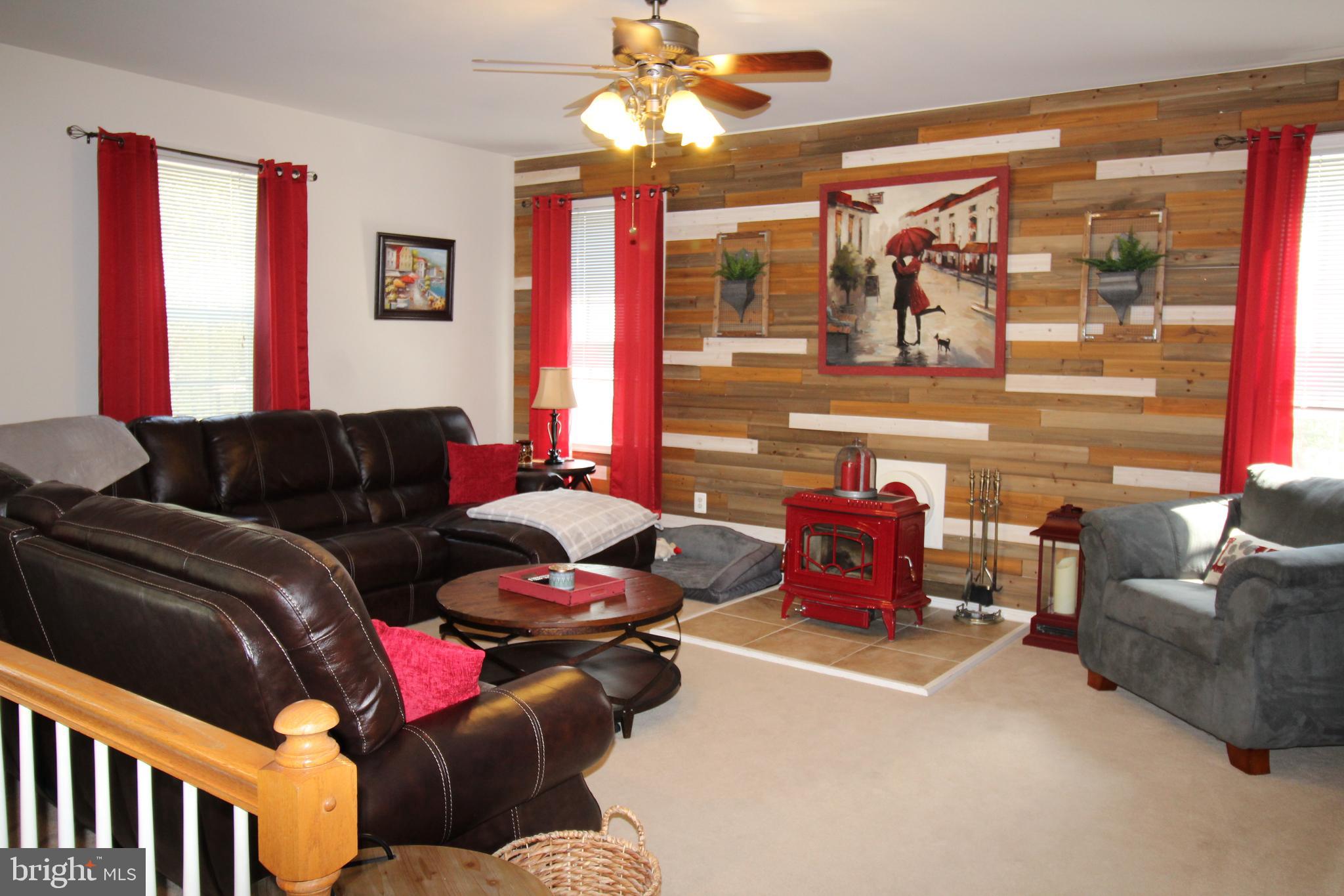 8250 Blossom Point Road Welcome, MD 20693 - Photo 12 of 54 Livingroom w/ Wood Planked Wall & Wood Stove