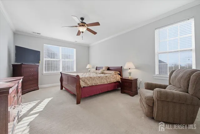 a spacious bedroom with a bed couch and window