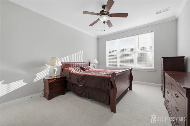 a spacious bedroom with a bed and a tv