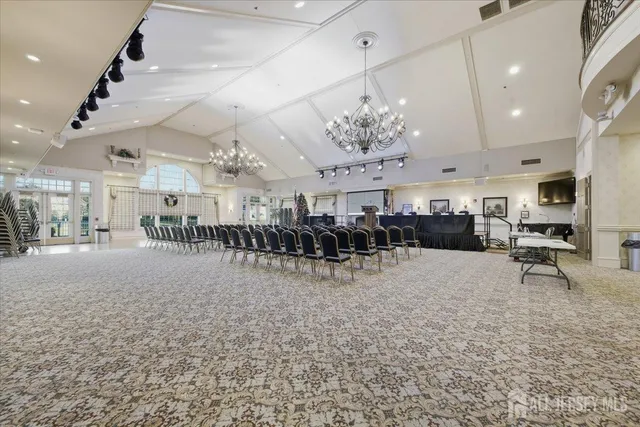 a view of a room with lots of furniture and lots of living room