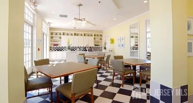 a view of a dining room with furniture and chandelier