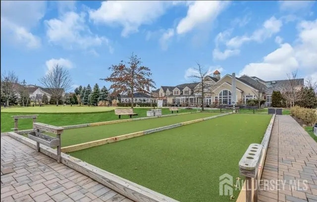 a view of a green field with sitting area