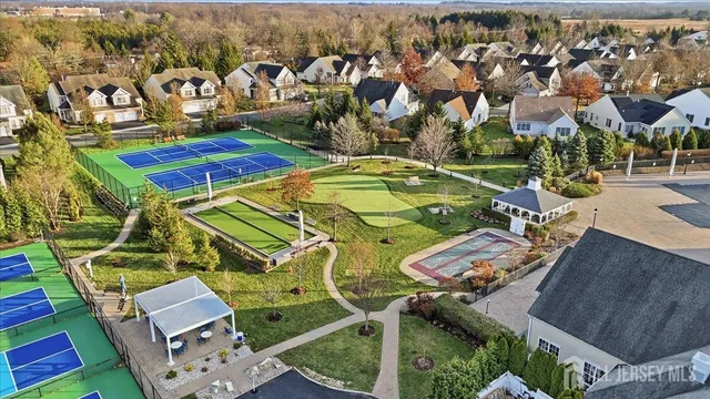 an aerial view of a pool patio chairs and fire pit