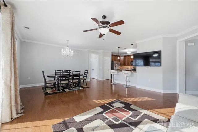 a living room with furniture and a view of kitchen
