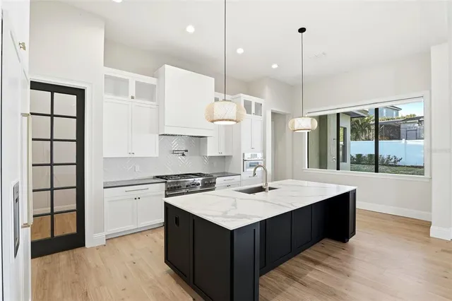 a kitchen with a stove sink and refrigerator