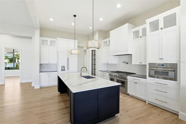 a kitchen with a sink stove and cabinets