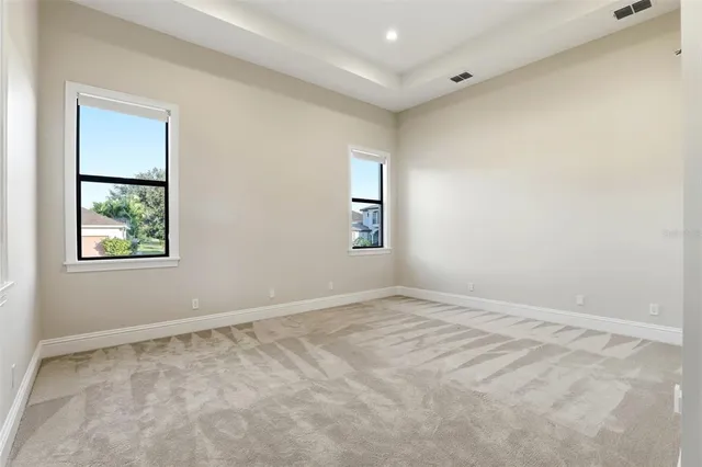 an empty room with windows and closet