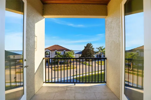 a view of swimming pool with outdoor seating and house in the background