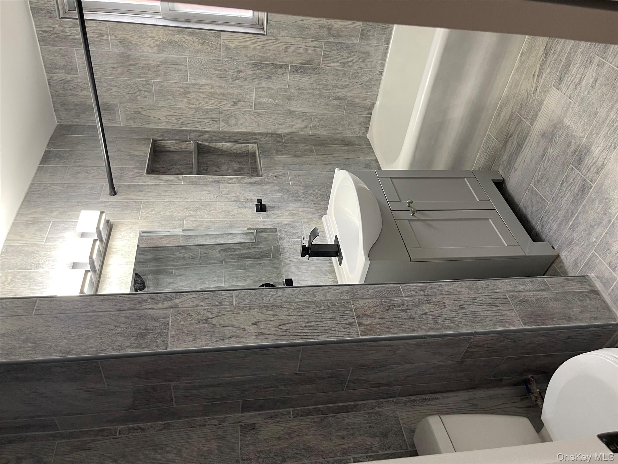 5783 Mosholu Avenue Bronx, NY 10471 - Photo 11 of 17 a bathroom with a sink a toilet and shower