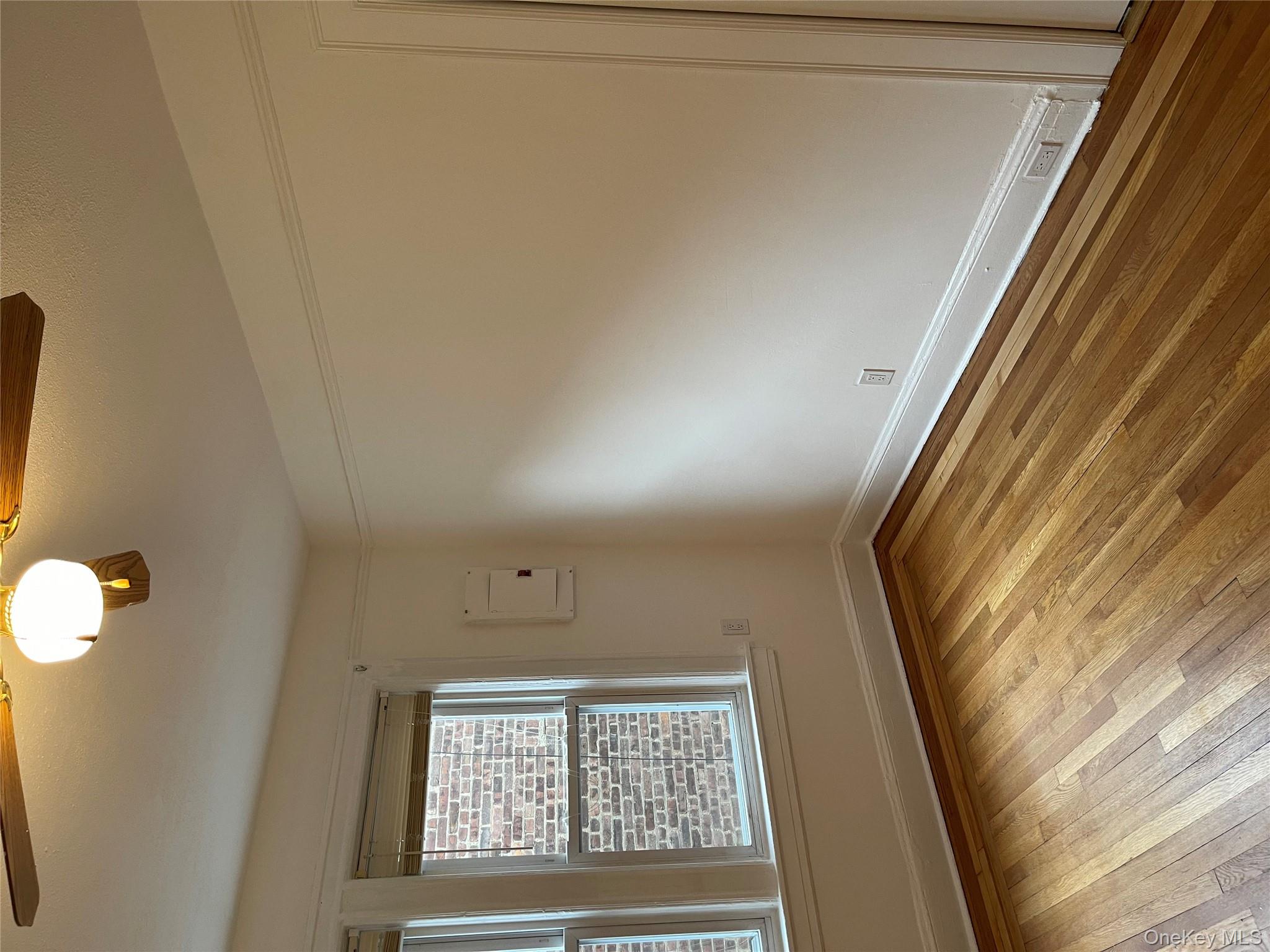 5783 Mosholu Avenue Bronx, NY 10471 - Photo 12 of 17 an empty room with wooden floor and windows