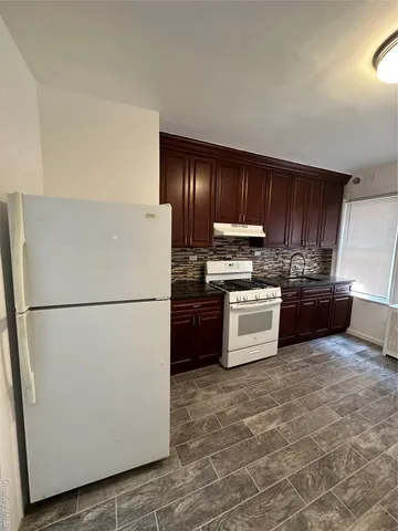 a white refrigerator freezer a stove sitting inside of a kitchen