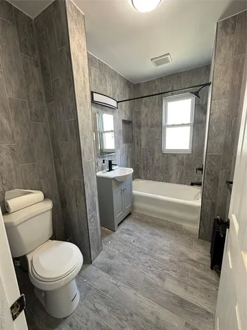 a bathroom with a bathtub toilet and sink
