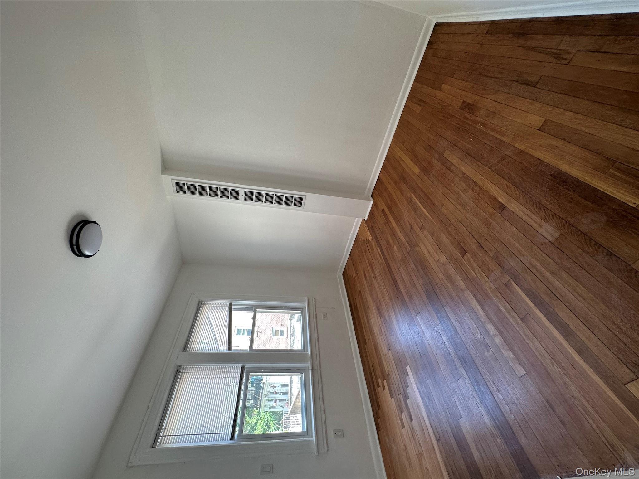 5783 Mosholu Avenue Bronx, NY 10471 - Photo 5 of 17 a view of empty room with wooden floor and fan