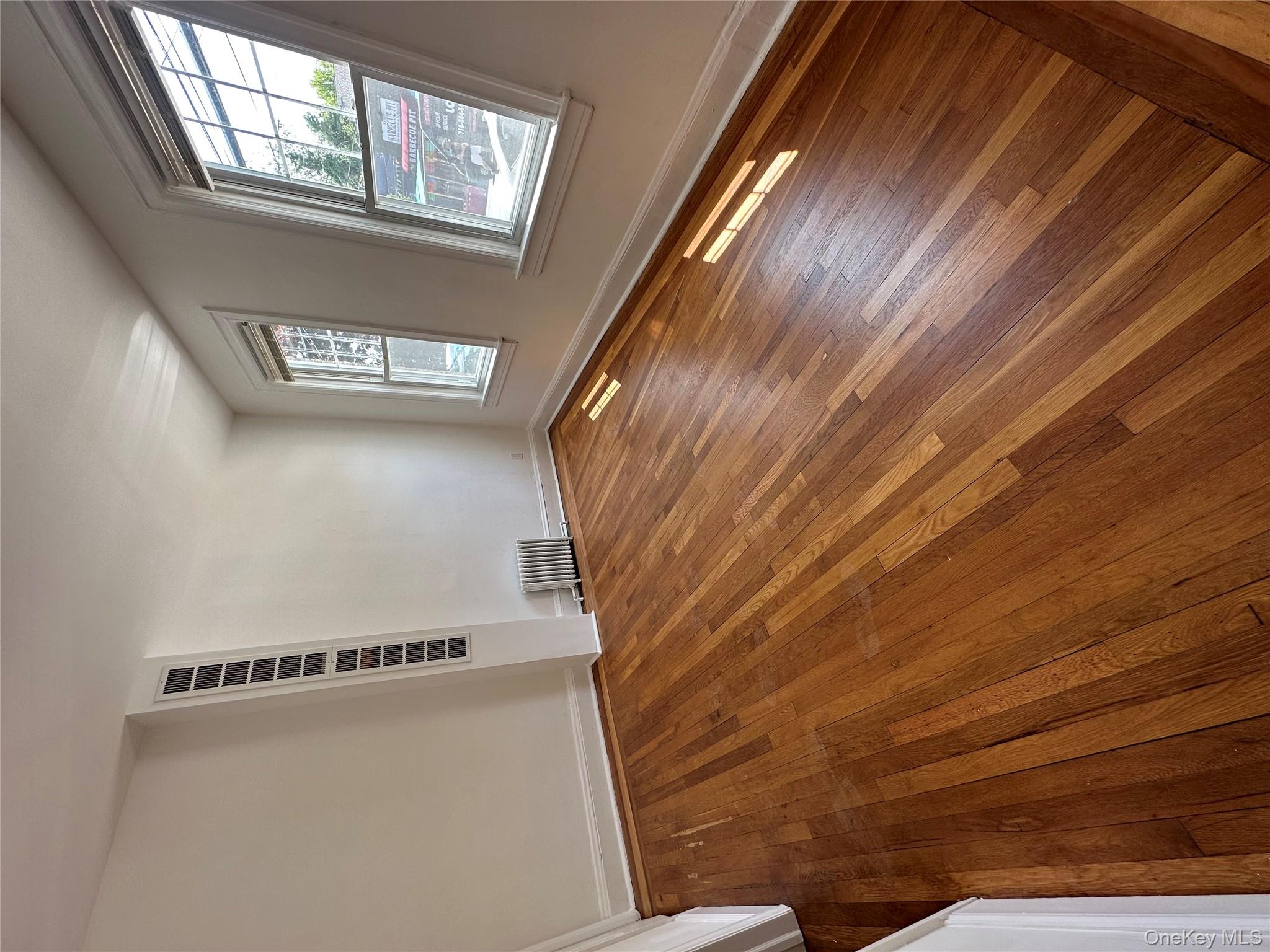 5783 Mosholu Avenue Bronx, NY 10471 - Photo 7 of 17 a view of empty room with window and wooden floor