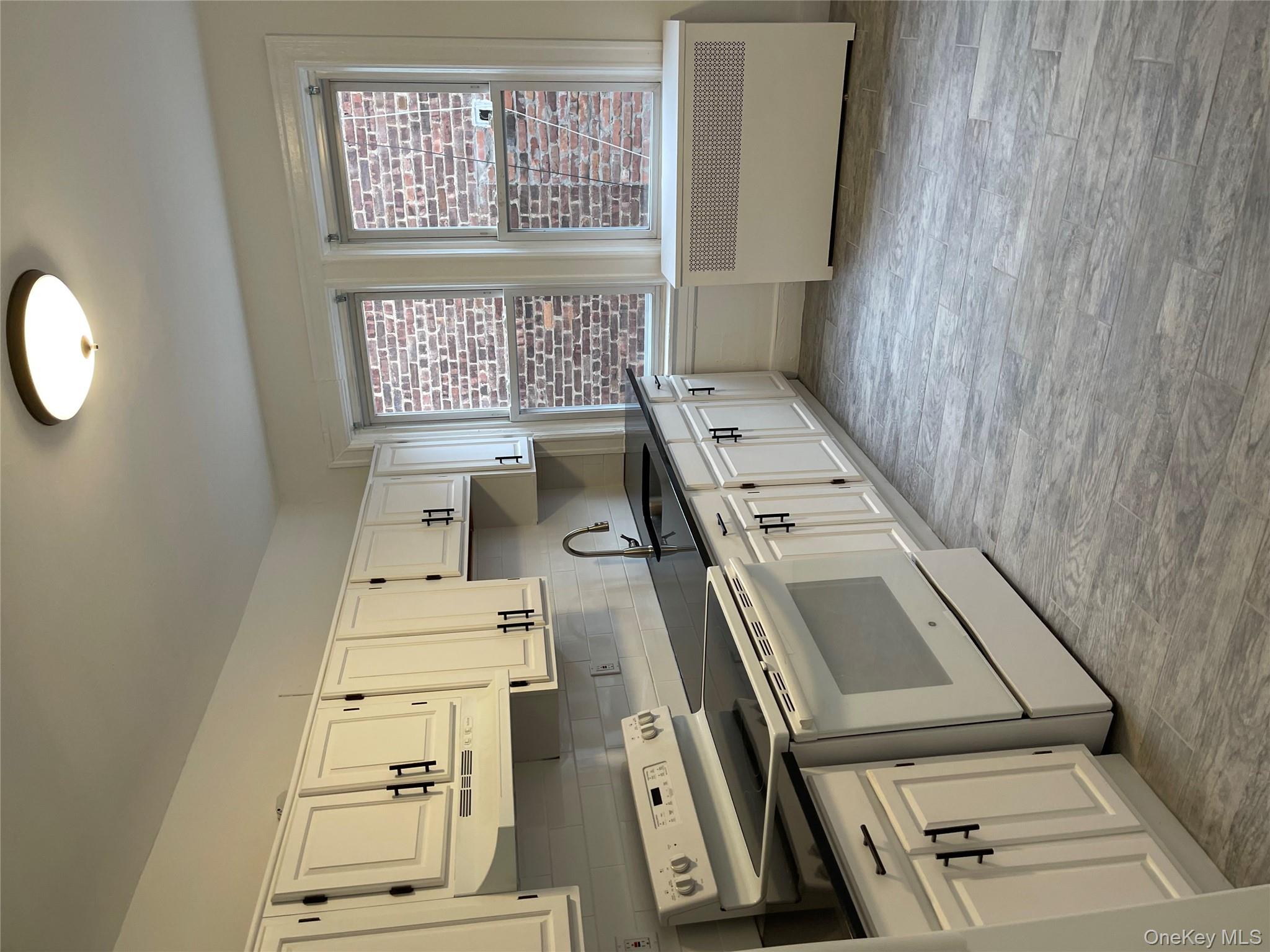 5783 Mosholu Avenue Bronx, NY 10471 - Photo 9 of 17 a kitchen with granite countertop a sink cabinets and stainless steel appliances