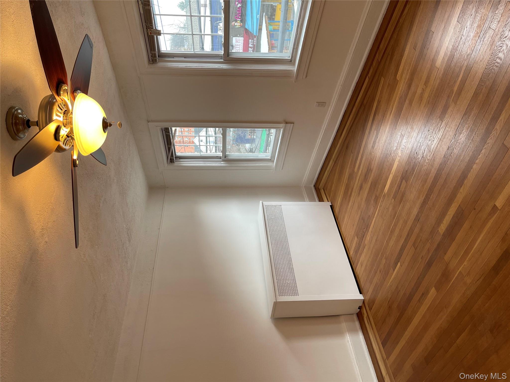 5783 Mosholu Avenue Bronx, NY 10471 - Photo 10 of 17 a view of empty room with wooden floor and fan