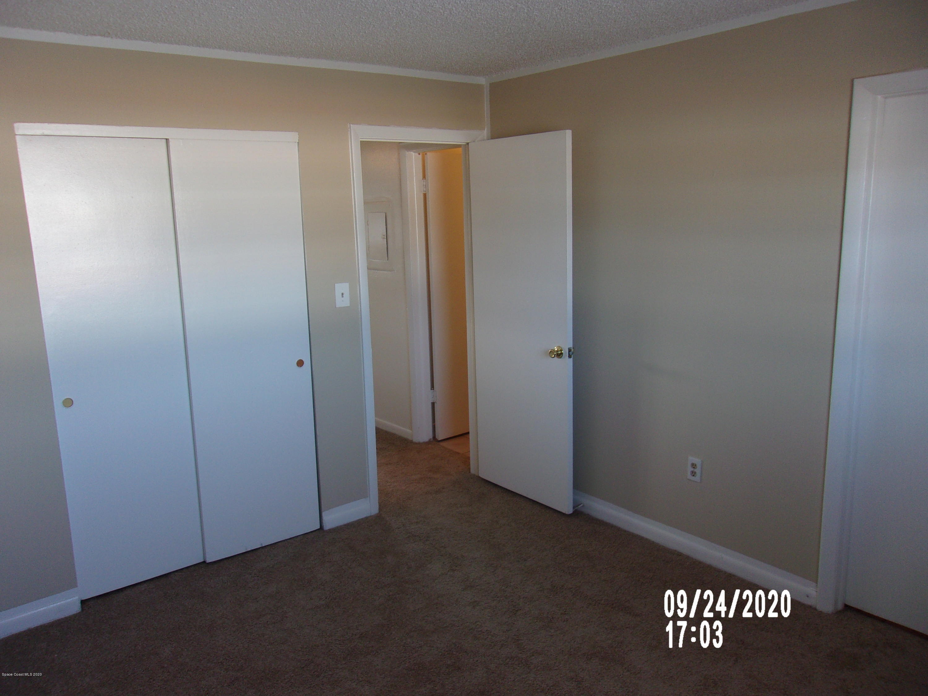 1713 Dixon Boulevard, Unit 156 Cocoa, FL 32922 - Photo 12 of 12 an empty room with a wooden door